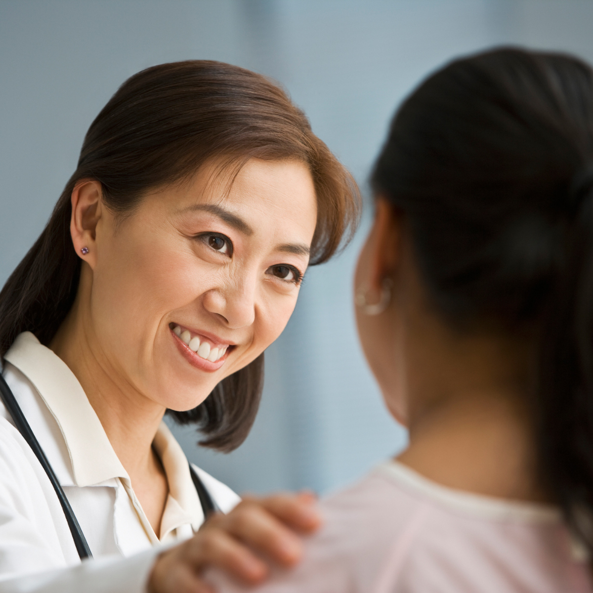 female doctor smiling at young patient