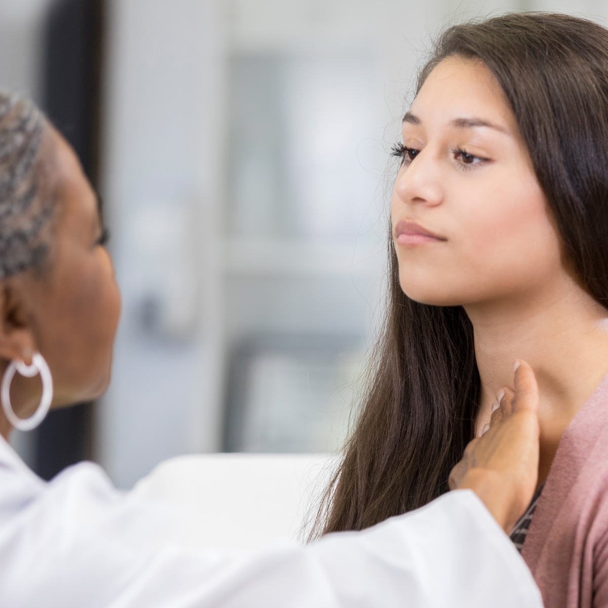 female doctor examining female patient