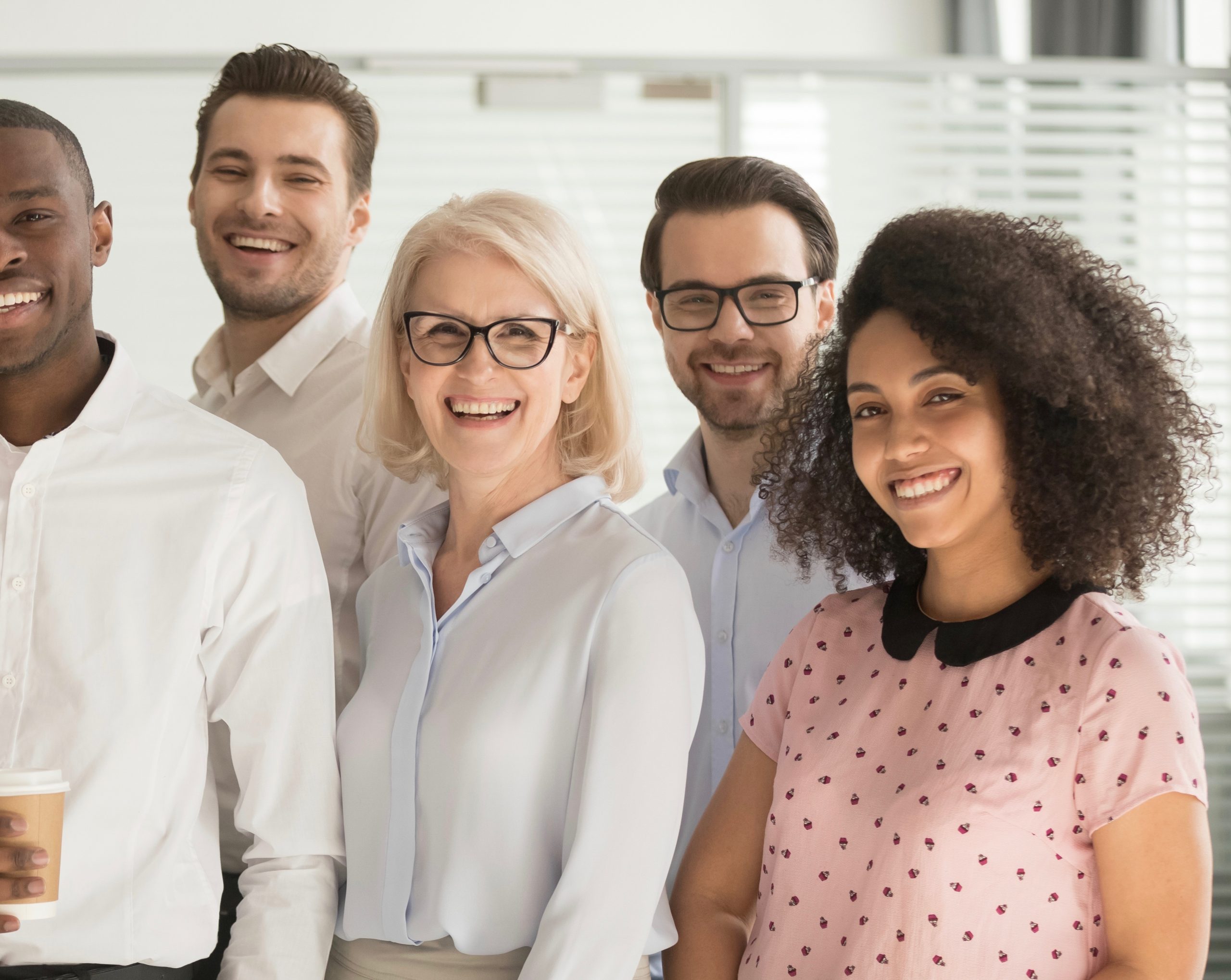 Motivated international multi-ethnic company members aged and young corporate team photographing posing for camera, successful staff portrait concept of growth in career leadership and racial equality