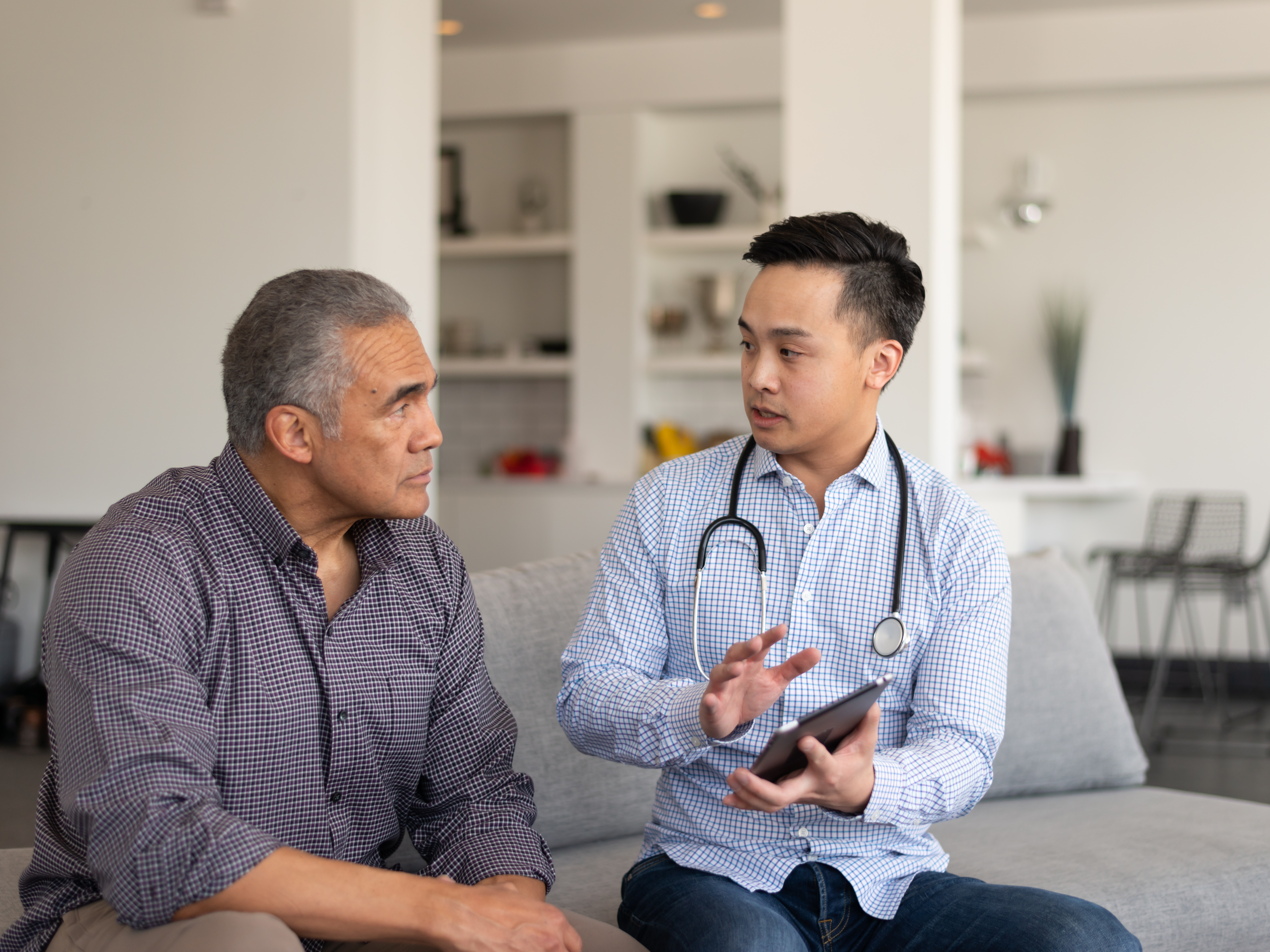 Asian provider consults older patient
